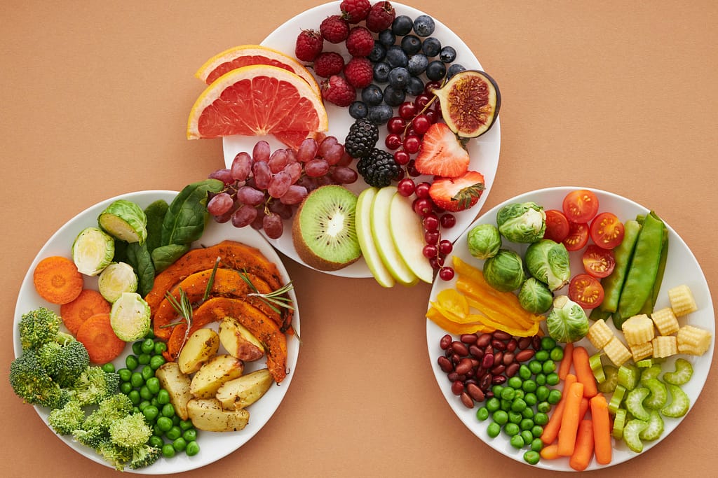 A vibrant bowl of leafy green vegetables and citrus fruits, symbolizing the importance of proper nutrition for eye health and vision preservation.