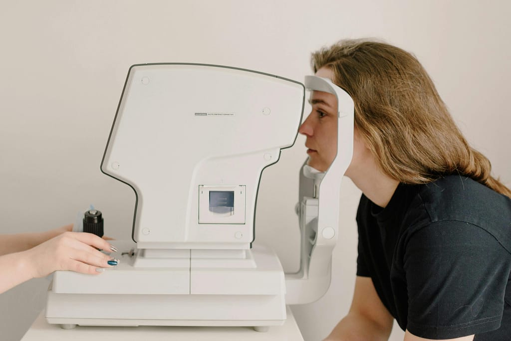 Eye specialist performing OCT scan to analyze retina and detect neurological indicators.
