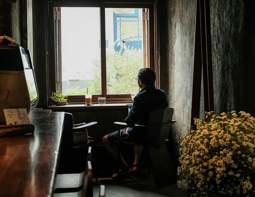 A person practicing the 20-20-20 rule by looking out the window