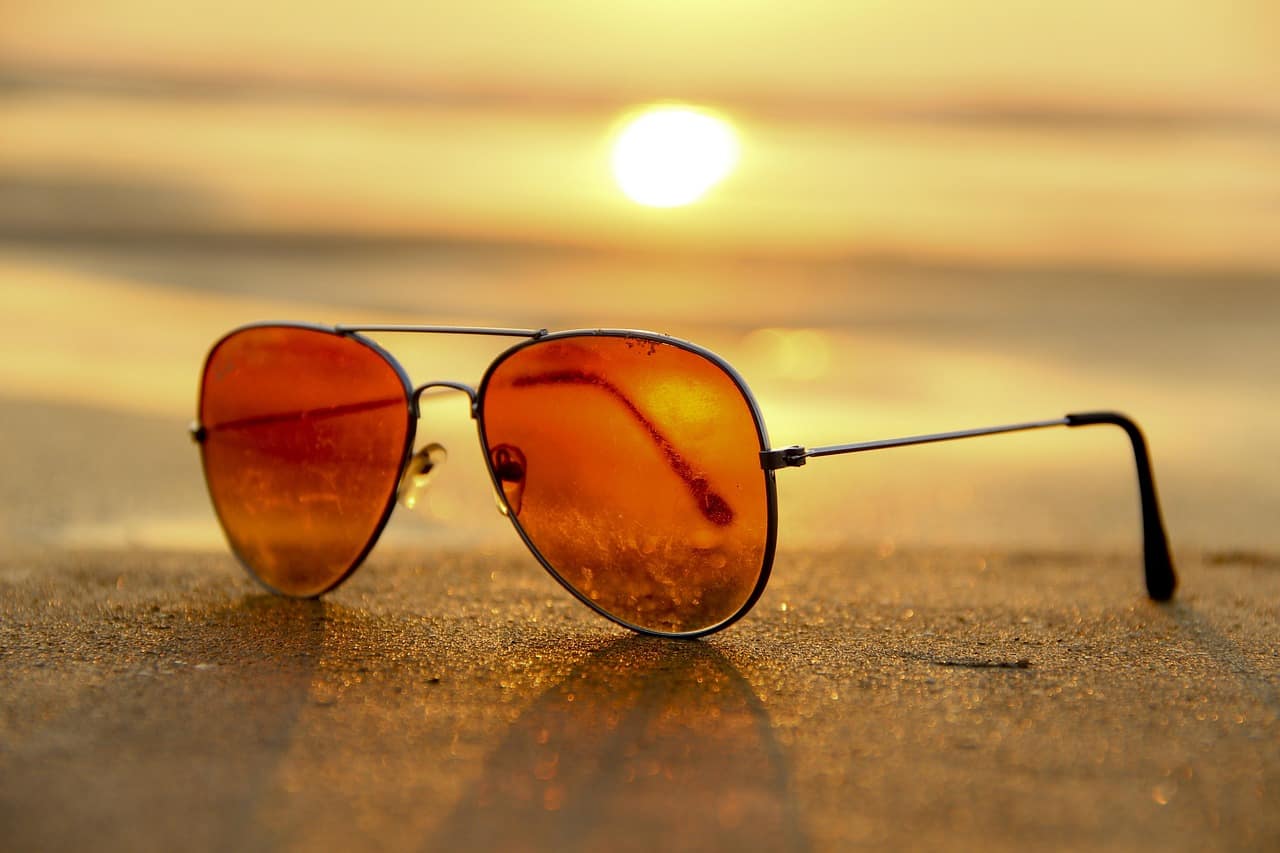 Luxury sunglasses reflection sunset