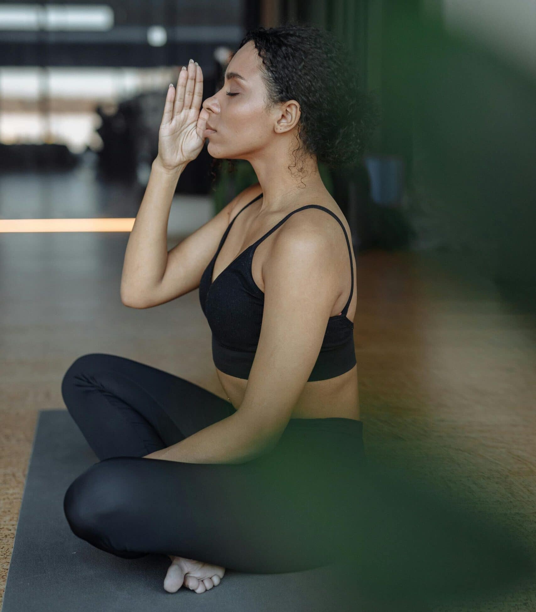 A woman performing morning eye exercises by the window to relax and refresh vision.