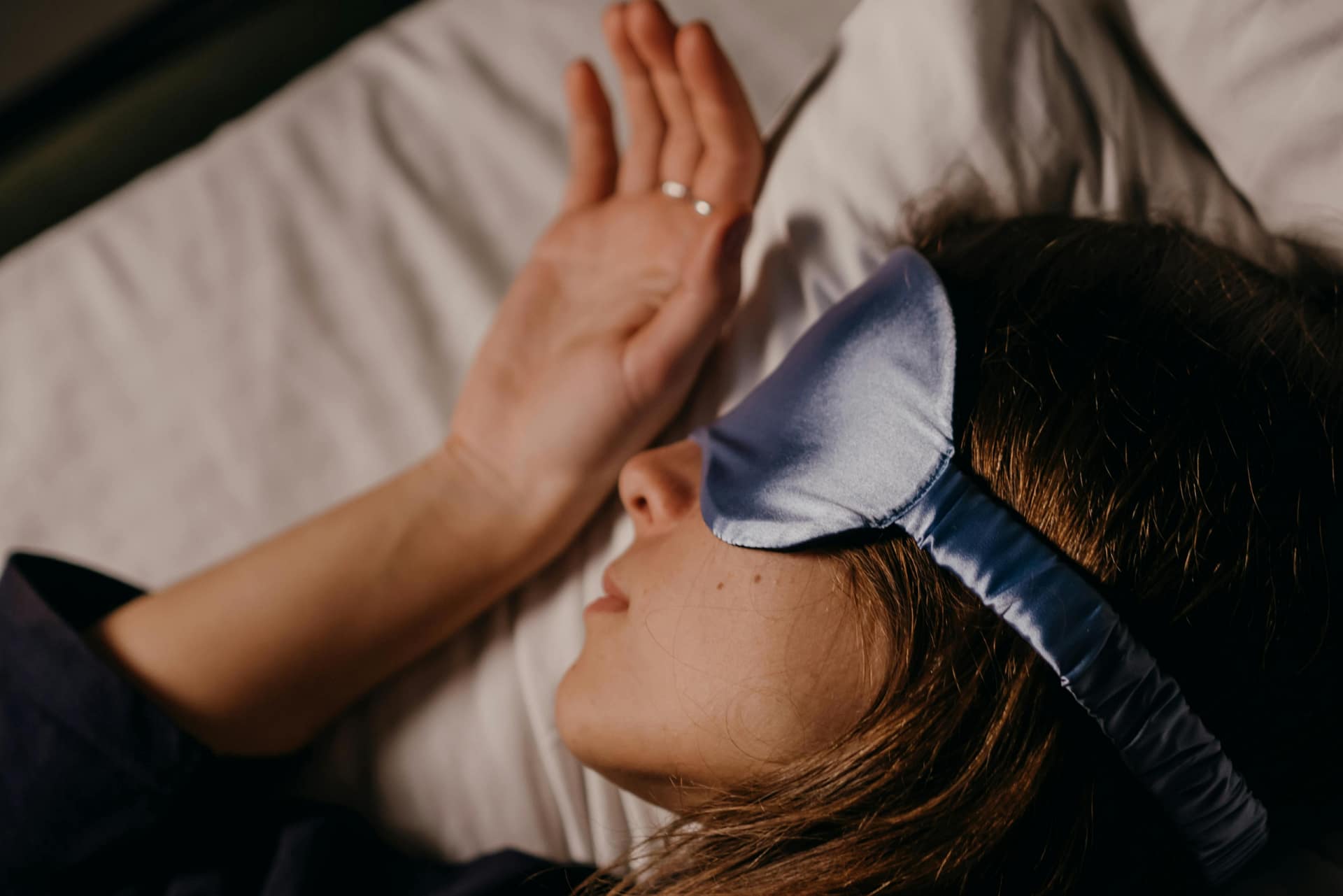 Relationship between sleep and eye health - person wearing a sleep mask