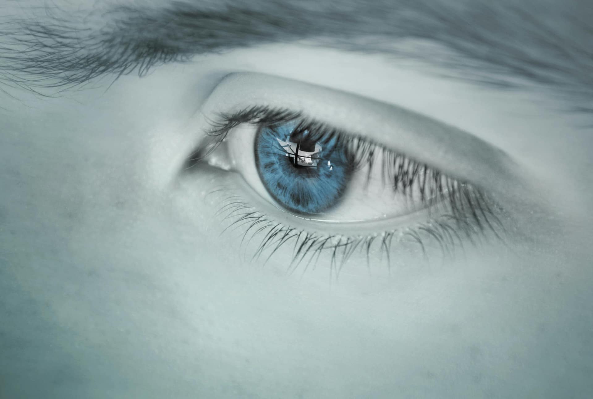 Close-up of a human blue eye representing clear vision and the importance of eye floaters awareness