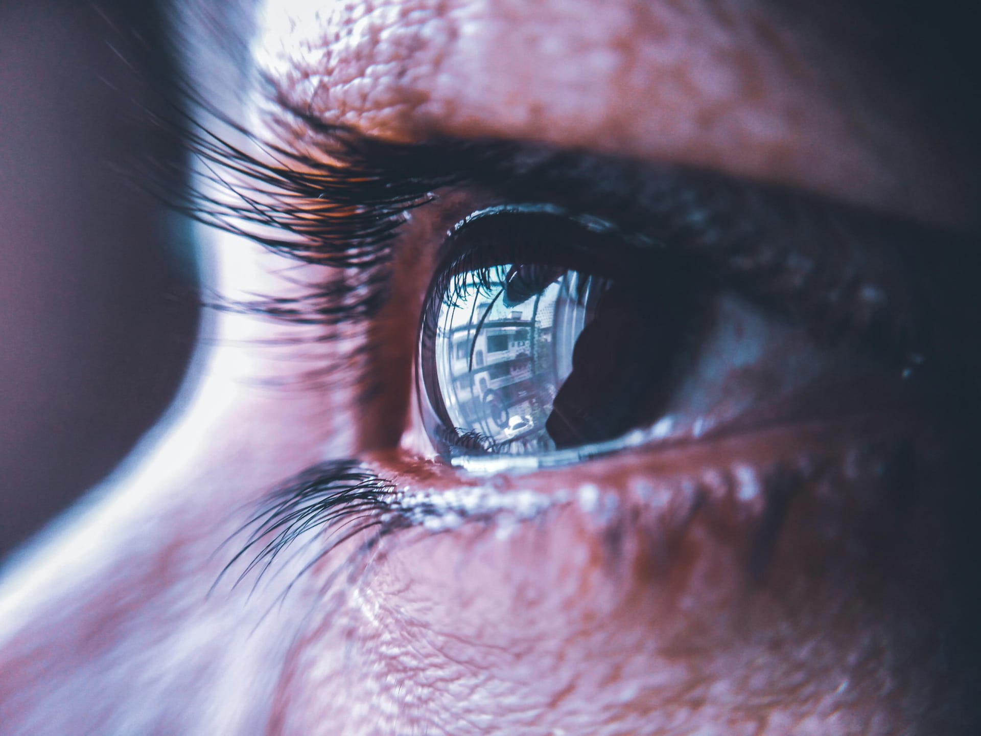Close-up microscopic view of the human eye showing transparent eye floaters (vitreous opacities) drifting across the field of vision, illustrating a common symptom.