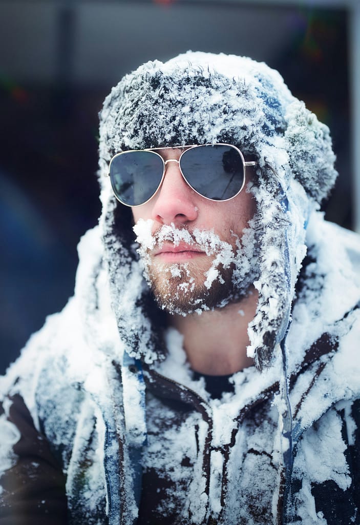 person wearing wrap around sunglasses snowy windy weather o protect itself from dry eyes in winter