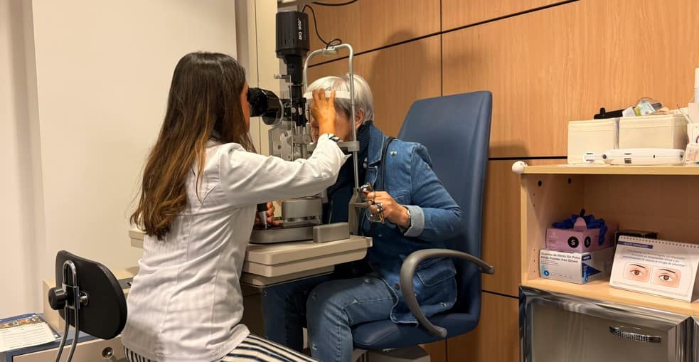 Ophthalmologist examining a senior woman’s eyes during a routine checkup. Vital Eye Care for Seniors and vision protection
